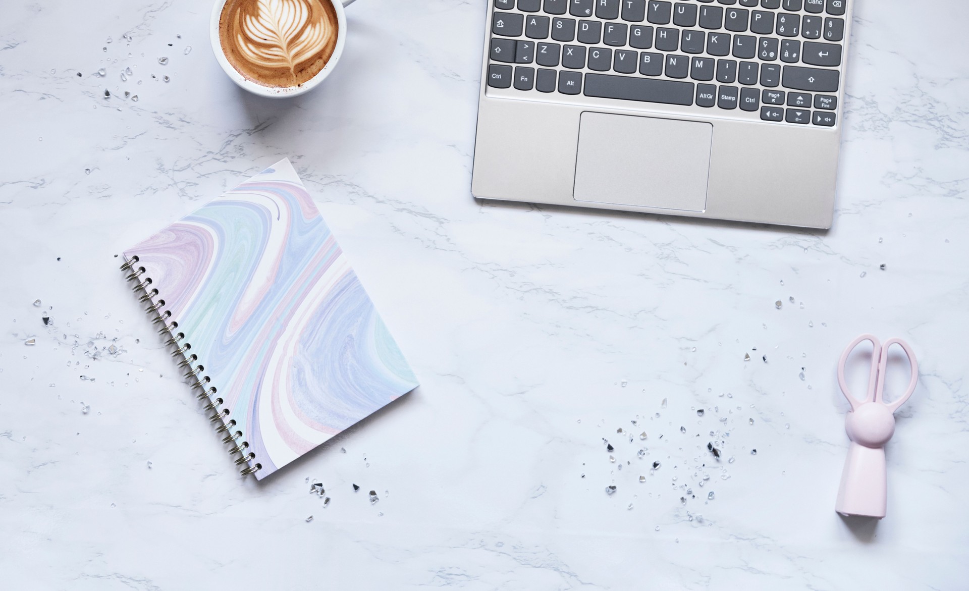 Paper note book on table with computer